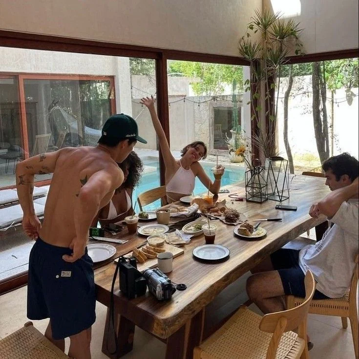 Friends around a lunch table after a swim